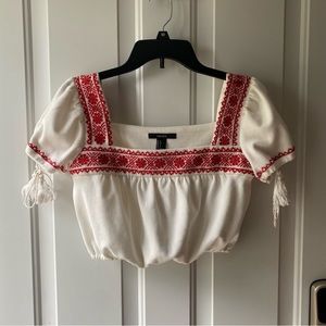White crop top with red detailing, slight puffy sleeves. Size Small. Forever 21